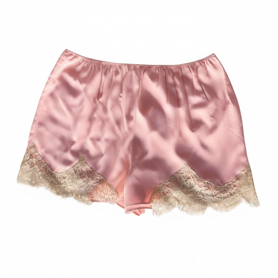 Light pink satin shorts with a beige lace hem, displayed flat against a white background.