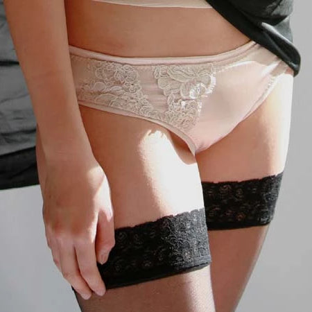 Model In Champagne Silk Brief With Black Lace Stockings