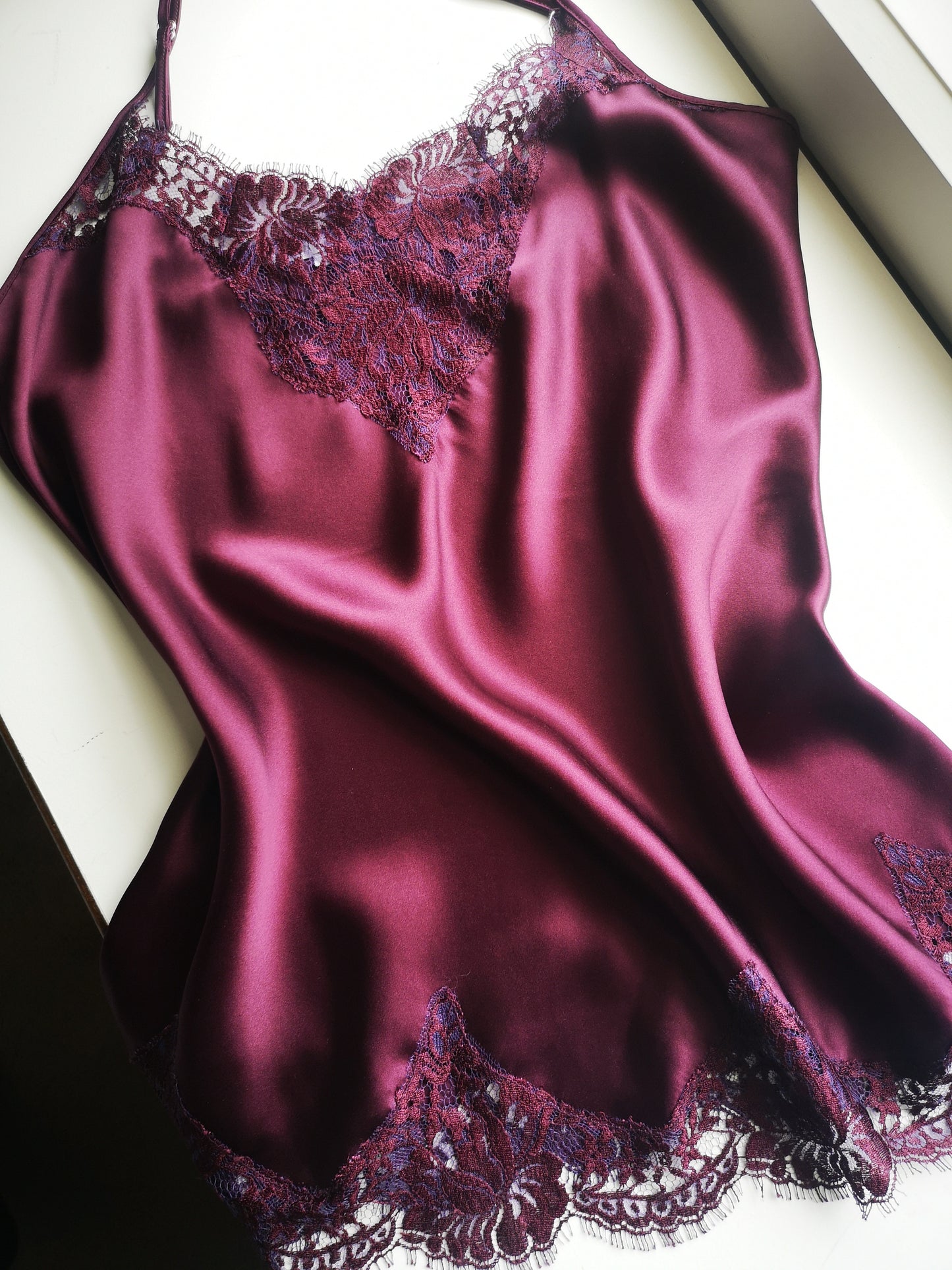 plum silk camisole made in melbourne at the natalie Begg Atelier. Trimmed with french lace. A truly exquisite piece that comforts you.